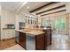 Modern kitchen featuring an island with a sink and stainless steel dishwasher at 13837 Grand Palisades Pkwy, Charlotte, NC 28278