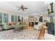 Open-concept living room with fireplace, and views into the kitchen at 13837 Grand Palisades Pkwy, Charlotte, NC 28278