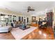 Open-concept living room featuring hardwood floors, neutral colors, a ceiling fan, and lots of natural light at 13837 Grand Palisades Pkwy, Charlotte, NC 28278