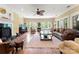 Spacious living room with a bay window, hardwood floors, fireplace, ceiling fan, and comfortable furnishings at 13837 Grand Palisades Pkwy, Charlotte, NC 28278