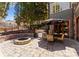 Outdoor firepit with seating, patio, and view of backyard and surrounding trees at 13837 Grand Palisades Pkwy, Charlotte, NC 28278