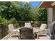 Outdoor patio with dining set perfect for al fresco meals with wooded view at 13837 Grand Palisades Pkwy, Charlotte, NC 28278