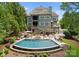 Stunning backyard featuring a large pool, spa, and patio area perfect for entertaining at 13837 Grand Palisades Pkwy, Charlotte, NC 28278