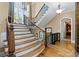 Elegant staircase with wood steps and wrought iron railing, bathed in natural light at 13837 Grand Palisades Pkwy, Charlotte, NC 28278