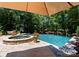 Inviting backyard pool with attached spa and lounge chairs with wooded view at 13837 Grand Palisades Pkwy, Charlotte, NC 28278