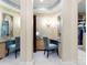 Elegant walk-in closet featuring custom vanity area with ornate mirror and adjacent custom clothes storage at 13837 Grand Palisades Pkwy, Charlotte, NC 28278