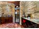 Custom wine cellar with stone walls, wine racks, and a refrigeration unit at 13837 Grand Palisades Pkwy, Charlotte, NC 28278