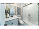 Modern bathroom featuring a sleek glass-enclosed shower, stylish vanity, and patterned tile flooring at 144 Asmodean Ln, Troutman, NC 28166