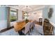 Elegant dining room with coffered ceiling, large window, and stylish table setting at 144 Asmodean Ln, Troutman, NC 28166