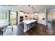 Modern kitchen featuring a large island, white cabinets, and stainless steel appliances at 144 Asmodean Ln, Troutman, NC 28166