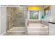 Well-lit bathroom featuring a soaking tub, walk-in shower, granite countertops, and tile flooring at 146 Asmodean Ln, Troutman, NC 28166