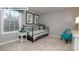 Comfortable secondary bedroom features a large window, carpet floors, and closet space at 146 Asmodean Ln, Troutman, NC 28166