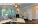 Open-concept living room with a fireplace, ceiling fan, and two sofas at 146 Asmodean Ln, Troutman, NC 28166