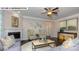 Spacious living room with fireplace, ceiling fan, and decorative wall art at 146 Asmodean Ln, Troutman, NC 28166