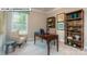 Home office area with wooden desk, built-in shelves, and natural light at 146 Asmodean Ln, Troutman, NC 28166