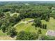 An aerial view showing a home with mature trees, greenery, and a long driveway at 151 Lillyfield Dr, Rockwell, NC 28138