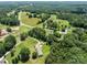Expansive aerial view of property showcasing the rural landscape, mature trees, and nearby roads at 151 Lillyfield Dr, Rockwell, NC 28138
