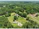 Aerial shot captures a home nestled among lush trees and vast open lawns at 151 Lillyfield Dr, Rockwell, NC 28138