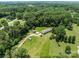 Bird's eye view of a home with a backdrop of dense trees and sprawling green lawns at 151 Lillyfield Dr, Rockwell, NC 28138