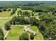 Expansive aerial view of property showcasing the rural landscape, mature trees, and nearby roads at 151 Lillyfield Dr, Rockwell, NC 28138