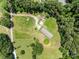 Picturesque aerial view of a property with a canopy of dense trees and a sprawling lawn at 151 Lillyfield Dr, Rockwell, NC 28138