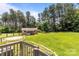 Spacious backyard featuring lush green grass, mature trees, and a charming storage shed at 151 Lillyfield Dr, Rockwell, NC 28138