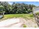 View of the lush backyard showcasing a level lawn, outbuilding, the home's siding, and the surrounding mature trees at 151 Lillyfield Dr, Rockwell, NC 28138