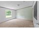 Neutral bedroom offering a window overlooking a lawn, light green walls and neutral carpeting at 151 Lillyfield Dr, Rockwell, NC 28138