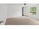 White bedroom offering a window overlooking a lawn and neutral carpeting at 151 Lillyfield Dr, Rockwell, NC 28138