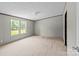Well lit bedroom with two bright windows and neutral carpet, perfect for relaxation and rest at 151 Lillyfield Dr, Rockwell, NC 28138