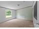 Large bedroom with a window overlooking the lawn, carpeting, and neutral paint at 151 Lillyfield Dr, Rockwell, NC 28138
