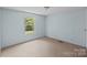 An empty bedroom with a window and bright white walls at 151 Lillyfield Dr, Rockwell, NC 28138
