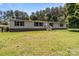 Ranch-style home featuring light siding and a brick foundation, set on a lush, green lot at 151 Lillyfield Dr, Rockwell, NC 28138