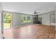 Inviting living room featuring a stone fireplace and large windows overlooking the yard at 151 Lillyfield Dr, Rockwell, NC 28138