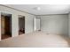 Open living room with multiple doorways, neutral carpet, and a smooth ceiling with simple lighting at 151 Lillyfield Dr, Rockwell, NC 28138