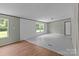 Large, bright room with sleek floors and ample natural light from the large windows at 151 Lillyfield Dr, Rockwell, NC 28138