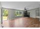 Bright living room with wood-look floors, stone fireplace, and a view of the outdoor greenery at 151 Lillyfield Dr, Rockwell, NC 28138