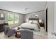 Cozy main bedroom with a bed, side tables, and lamps, all beneath a smooth textured ceiling at 151 Lillyfield Dr, Rockwell, NC 28138