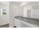 This bathroom features dual sinks with granite counters, a large mirror, and a walk-in shower at 155 Trail Wood Ct, Salisbury, NC 28146