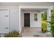 Charming front porch with an inviting entrance featuring a black front door and decorative flower basket at 155 Trail Wood Ct, Salisbury, NC 28146