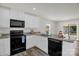The kitchen features granite counters, black appliances, white cabinetry, and access to outdoor living space at 155 Trail Wood Ct, Salisbury, NC 28146