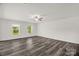 A spacious living room with hardwood floors, windows, and a ceiling fan at 155 Trail Wood Ct, Salisbury, NC 28146