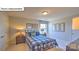 Bedroom featuring a plaid bed with blue accents and wooden nightstands with lamps at 160 Asmodean Ln, Troutman, NC 28166