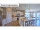 Open kitchen and dining area with granite countertops and stainless steel appliances at 160 Asmodean Ln, Troutman, NC 28166