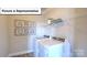 Representative laundry room with modern appliances and convenient shelving at 160 Asmodean Ln, Troutman, NC 28166