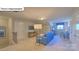 Bright living space with blue sofa, desk, shelving unit, TV, and neutral decor, creating a cozy atmosphere at 160 Asmodean Ln, Troutman, NC 28166