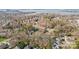 Aerial view of residential neighborhood; the property is outlined in yellow with lush trees and lake views at 20016 Walter Henderson Rd, Cornelius, NC 28031
