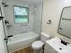 This is a renovated bathroom with a tub, and modern white and black fixtures at 20016 Walter Henderson Rd, Cornelius, NC 28031
