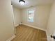 This is a bedroom with wood flooring, one window, and neutral colored walls at 20016 Walter Henderson Rd, Cornelius, NC 28031