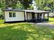 Charming single-story home with a gravel driveway, spacious yard, and lush mature trees offering great curb appeal at 20016 Walter Henderson Rd, Cornelius, NC 28031